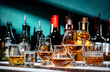 Strong hard alcoholic drinks, spirits, liqueurs, distillates, whiskey and others in glasses and...