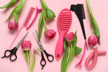 Hairdresser's tools with beautiful tulips on pink background