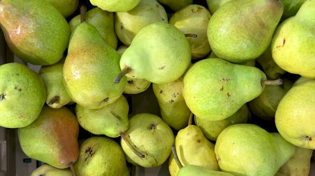 Williams pears in cardboard crate at the grocery store, tracking shot in top view