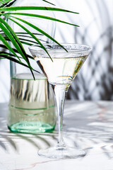 Italian white bianco vermouth in glass and bottle on white background