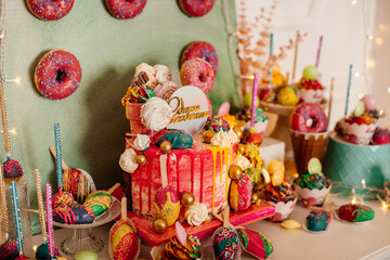 A vibrant dessert table filled with cake, donuts, and treats—perfect for birthdays, celebrations, or party inspiration.