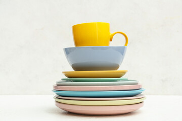 Stack of clean tableware on white background