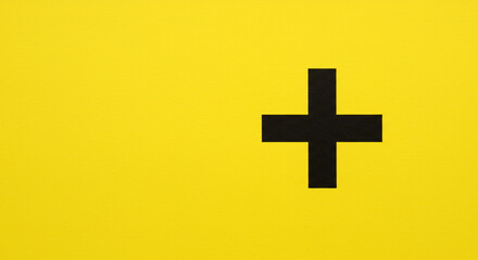 Obraz premium A bold black cross against a vibrant yellow background, symbolizing hope, faith, and positivity with a minimalist design aesthetic.