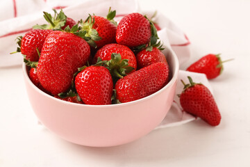 Bowl with sweet fresh strawberries on white background