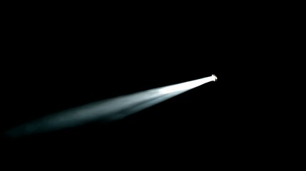 A focused beam of bright white light shoots across a solid black backdrop, creating a dramatic contrast. A beacon in the darkness