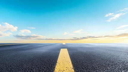 Naklejka premium Empty Asphalt Road With Yellow Line Under Pale Sky