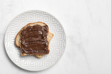 Plate of toasts with sweet chocolate spread on white background