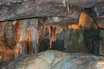 A cave with a brown ceiling and a white floor