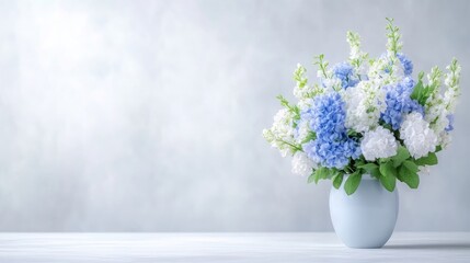 Light blue and white floral arrangement in a vase