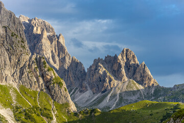 Dolomites, Alpi Dolomiti beautiful scenic mountain landscape under blue sky in summer. Rocky tower peak summits of the Alps on a sunny day. Alpine scenic view of the cliffs and climbing walls in Italy