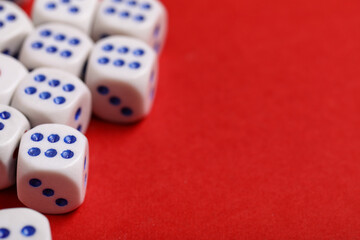 White game dices on red background, closeup