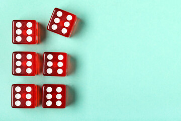 Red game dices on turquoise background