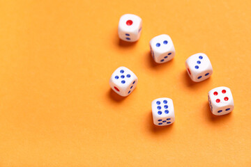 White game dices on orange background, closeup