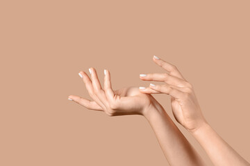 Female hands on beige background