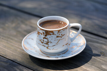 cup of coffee on wooden table