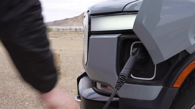 Hand Plugging In Electric Adventure Truck - Green Charging Indicator Turning On & Connection