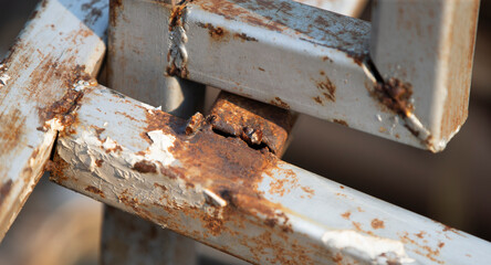 Detail of an old rusty iron fence. Shallow depth of field.