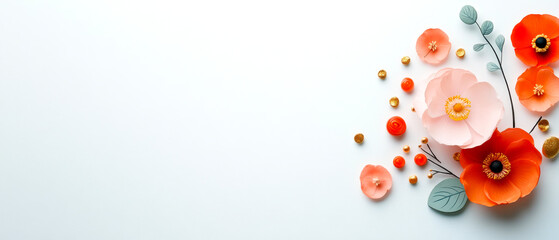 A beautiful arrangement of colorful paper flowers, including orange and pink blooms, against a clean, white background, creating a fresh and artistic feel.