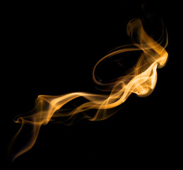gold yellow smoke, abstract element smog isolated on a black background.  concept of texture mist, fog effect, and cloud for design air pollution
