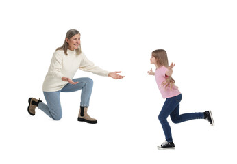Happy girl running towards her grandmother on white background