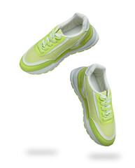 Stylish green sneakers in air on white background