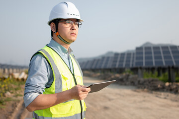 Fototapeta premium asian engineer working on digital tablet in solar power station