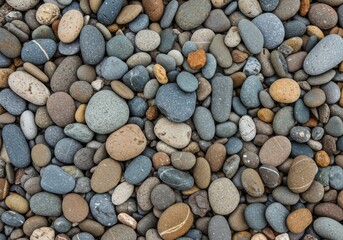 A close up shot showing a collection of smooth beach stones of various sizes and colors together