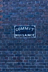 Commit nuisance painted on a wall