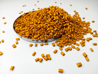 Orange masterbatch granule, orange polypropylene polymer granules, cold cutting type granule texture, isolated on white background, for industrial plastic company profile product catalog design	