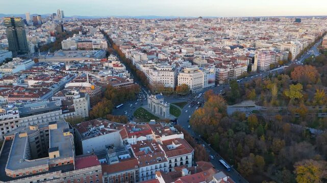 Stunning aerial drone shots of Madrid at sunset, featuring the iconic Puerta de Alcal and El Retiro park amidst a vibrant cityscape and history of Europe. Spain