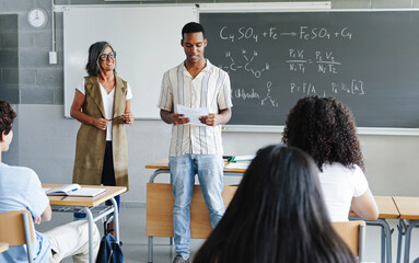 African American student doing academic science presentation to classmates and teacher at College
