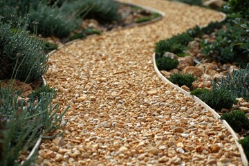 Curved gravel pathway surrounded by greenery and plants.