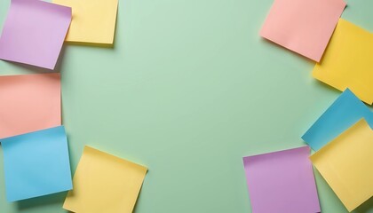 Colorful sticky notes framing a mint green background - creative space for ideas