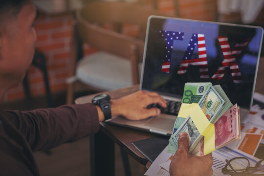 Businessman holding money banknotes and seriously about American tax problem. Selected focus	