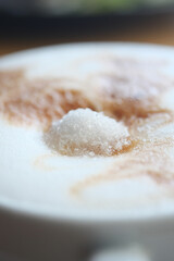 sugar pouring on a coffee 