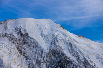 Mont Blanc, Monte Bianco mountain summit snow dome above the Chamonix valley in France. Highest peak in Europe in the Alps, alpine scenic view of Montblanc