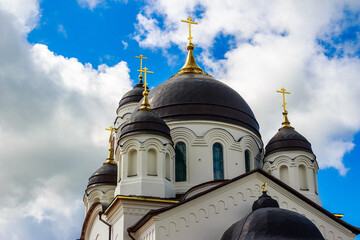 Domes with gilded crosses of the Old Believer Pokrovsky Cathedral in the city of Borovsk, Russia