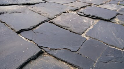 Cracked Asphalt Tiles Close Up Showing Weathered Black and Gray Patterned Flat Surface