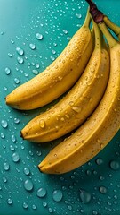 Ripe yellow bananas with water droplets on a teal background