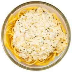 Plate contains portion of pasta carbonara - boiled long spaghetti with thick sauce based on cream and fried bacon. Isolated over white background