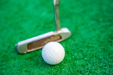 Mini-golf clubs and balls on artificial grass. Family vacations or resort. 