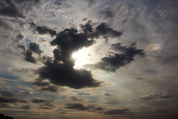 Fototapeta premium A dark cloud in the sky blocks the light of the sun