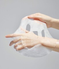Moist hands that are spreading their mask packs