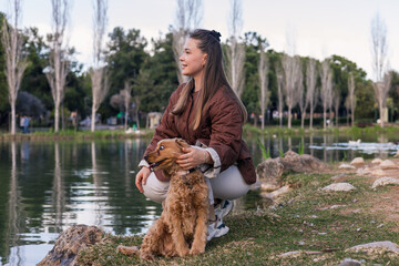 Cocker spaniel and owner share a joyful moment by the water on a sunny day