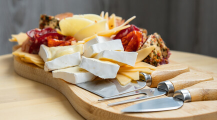 Wooden charcuterie cheese board holiday present idea. Snack starter plate for dinner with wine....