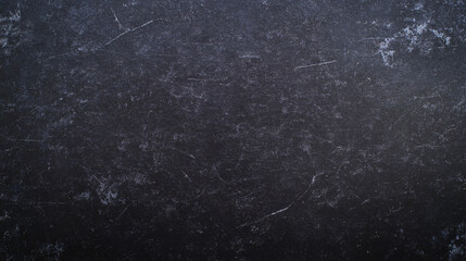 Dark textured surface with subtle scratches and imperfections, creating elegant backdrop