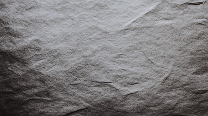 Textured dark gray paper with vintage feel, showcasing subtle wrinkles and depth