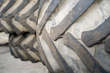 Old worn tractor tires lie in the garage awaiting disposal or recycling.