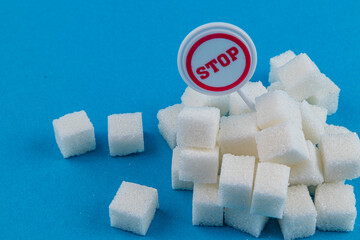 Awareness campaign against sugar consumption with sugar cubes and sign