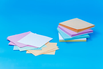 Colorful Square Paper Sheets on Blue Background
